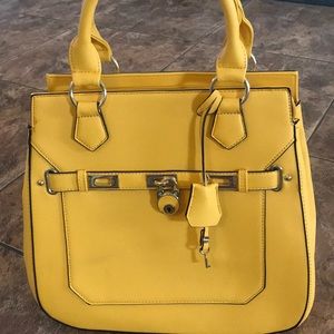 Yellow handbag with lock and key